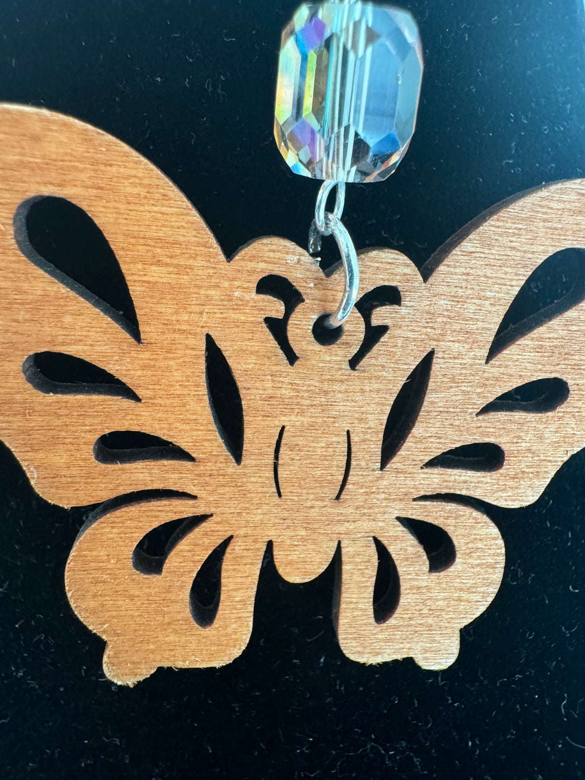Detail of the openwork butterfly design and wood grain