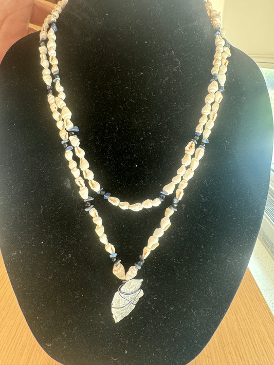 Shell and blue-bead necklace with a wrapped arrowhead-shaped pendant