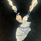 Close-up of shell beads, blue accents, and the wrapped pendant