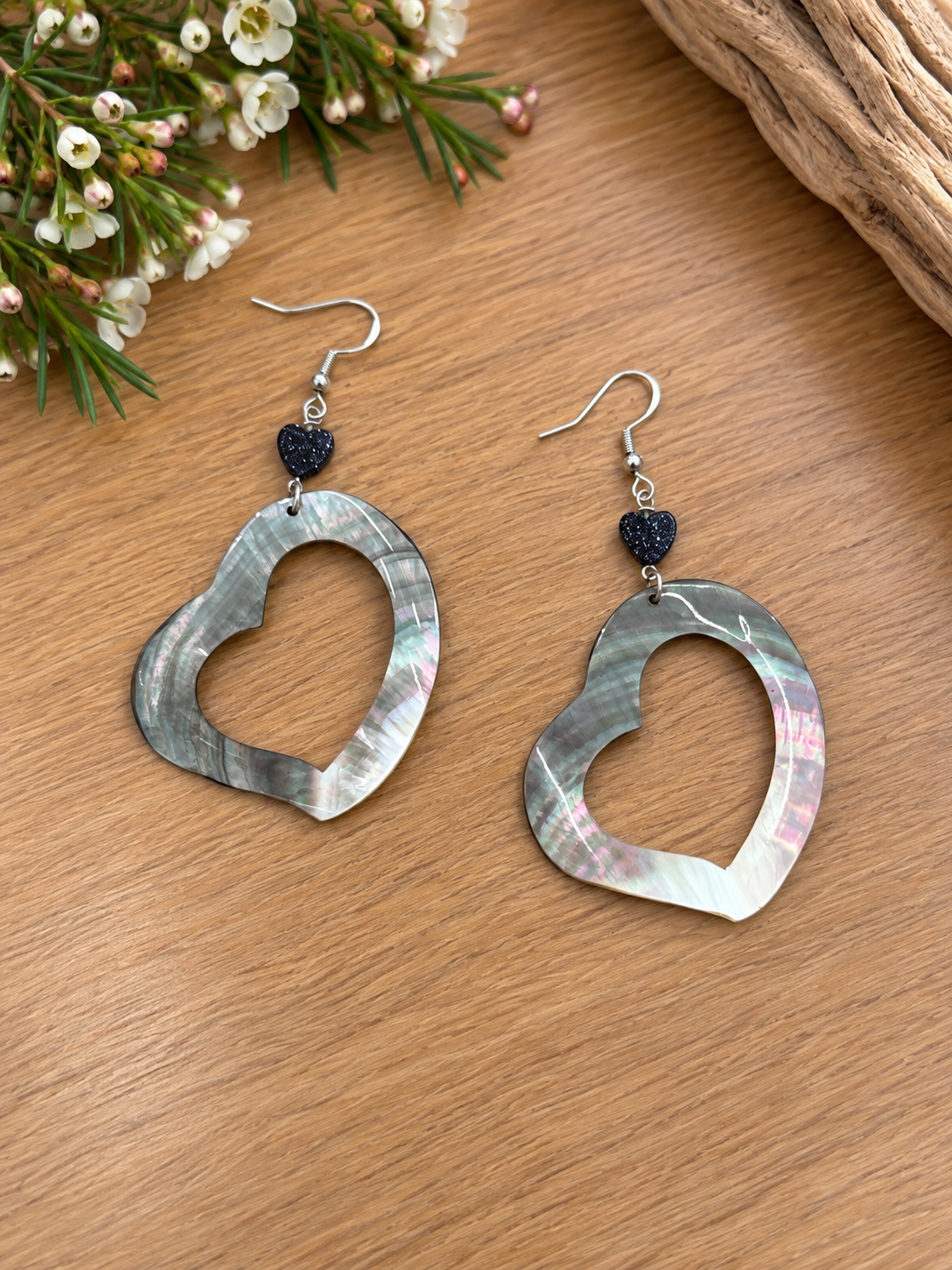 Open-heart black lip shell earrings with faceted black beads