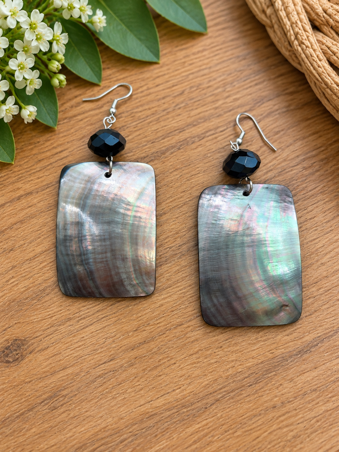 Rectangular black lip shell earrings with faceted black beads
