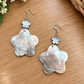 Large iridescent shell flower earrings with small pale flower accents