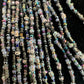 Close-up of gray and iridescent seed-bead strands