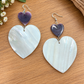 Mother-of-pearl heart earrings with smaller purple heart accents