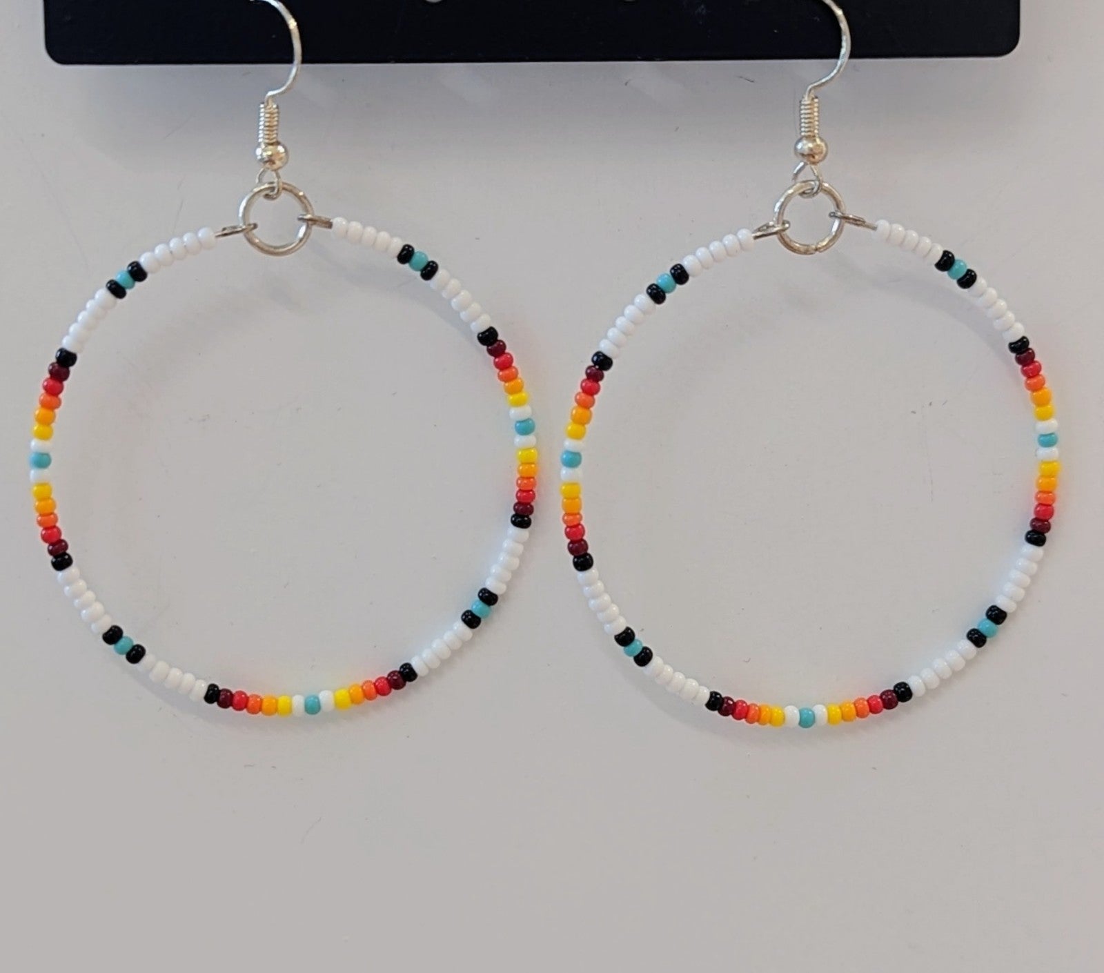 White beaded store hoop earrings